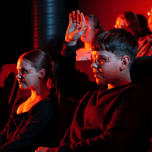 A little boy raising his hand at the Lava Show in Reykjavik.