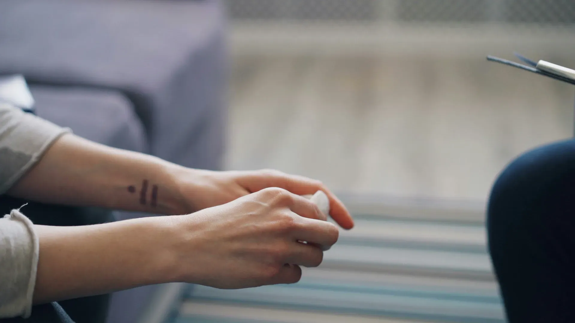 Hands of a person holding a small piece of paper