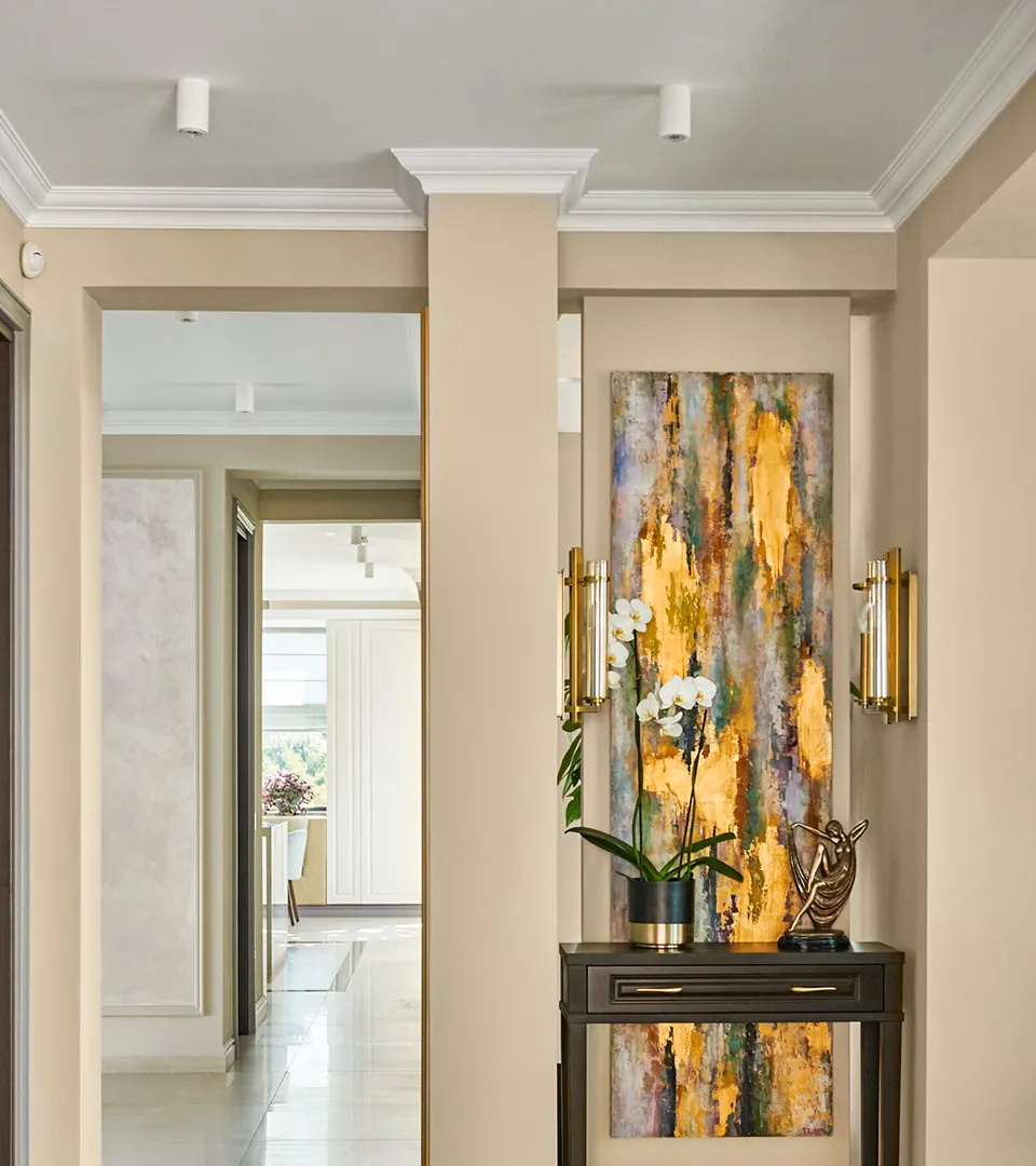 Villa Belmare hallway styling with console table, statement abstract artwork, and wall sconces