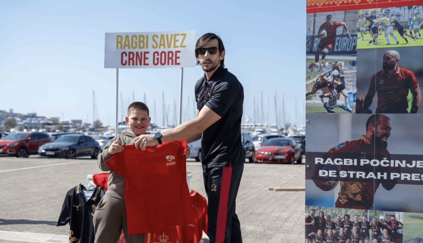 kid with rugby union t-shirt in front of promotion banner
