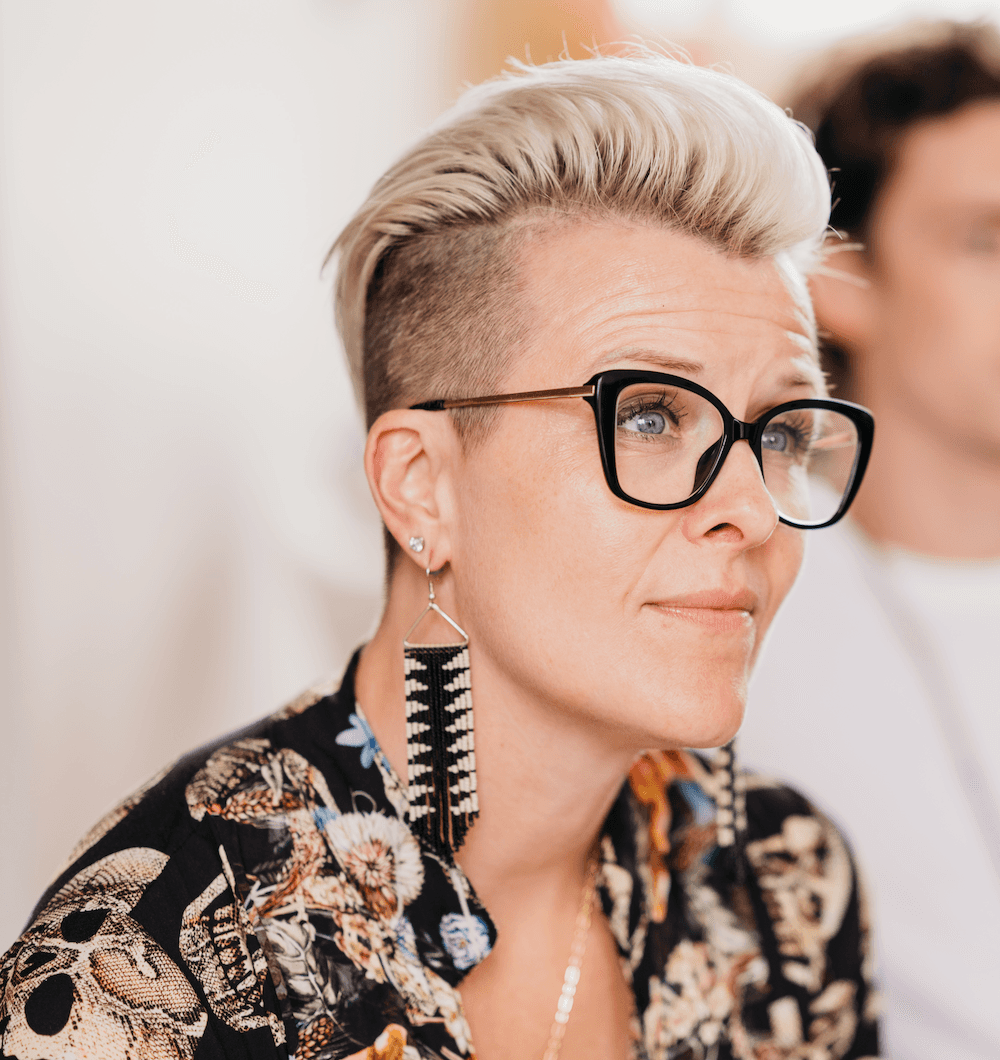 Black and white portrait of a smiling person with curly hair