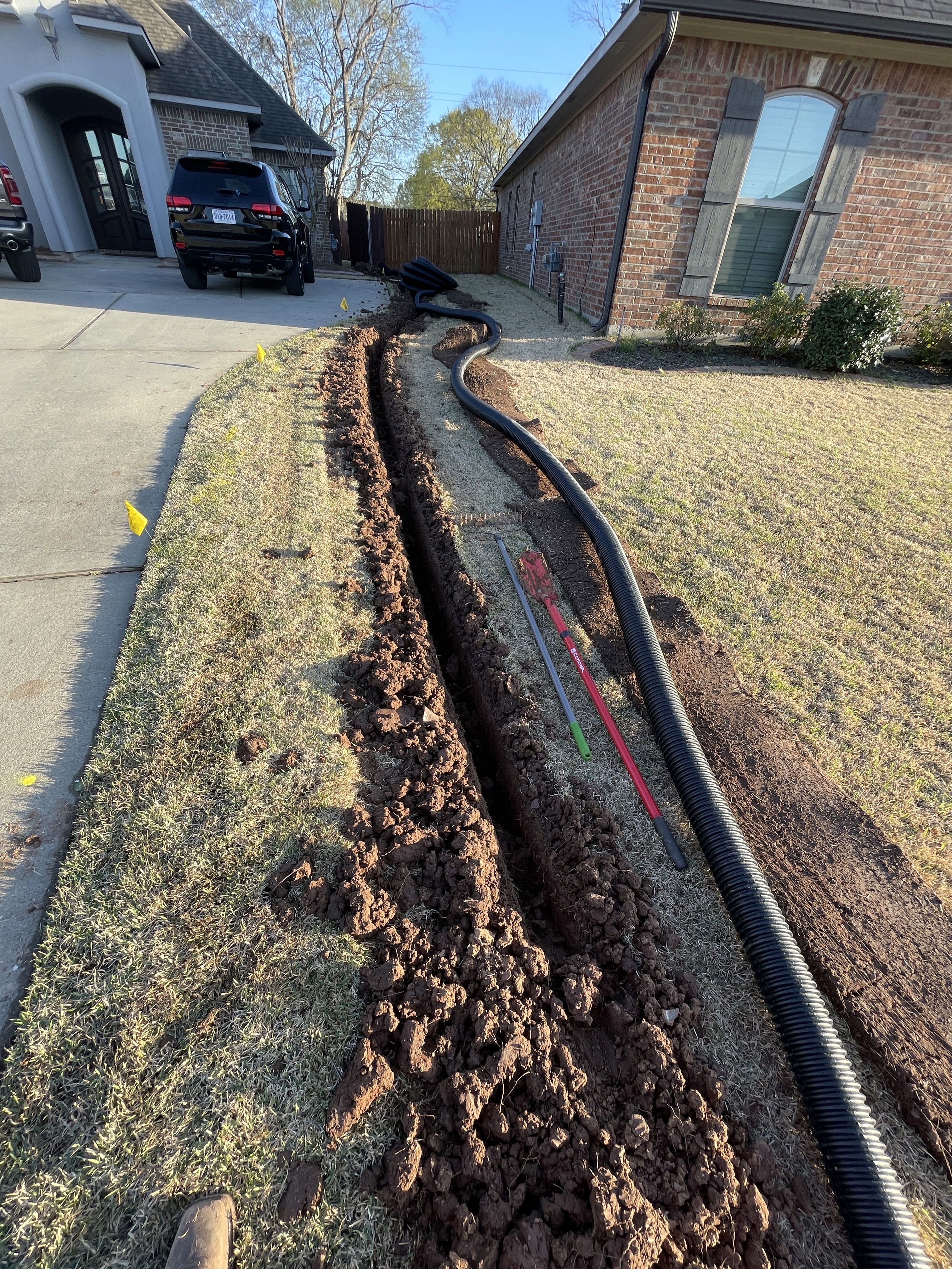 Shreveport yard drainage installation by Barefoot Lawns to protect homes from water damage.