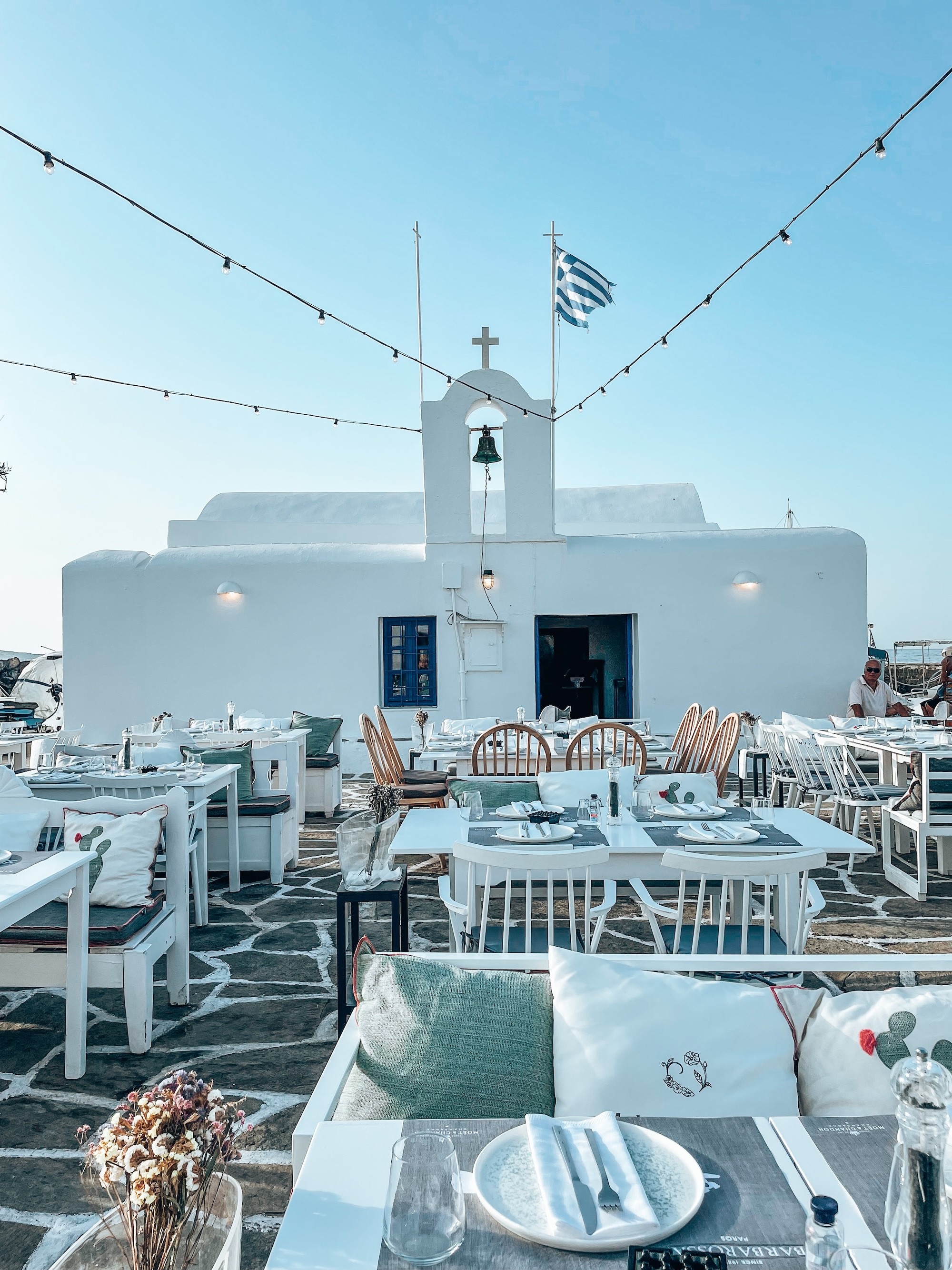 Graphic church and a dining area of the restaurant in Naousa