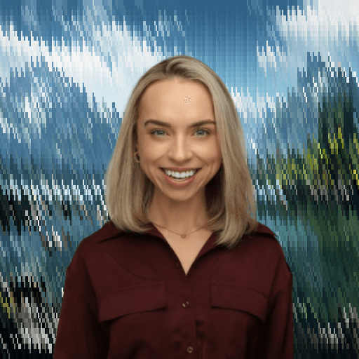 Professional portrait of a woman smiling against a scenic outdoor background.