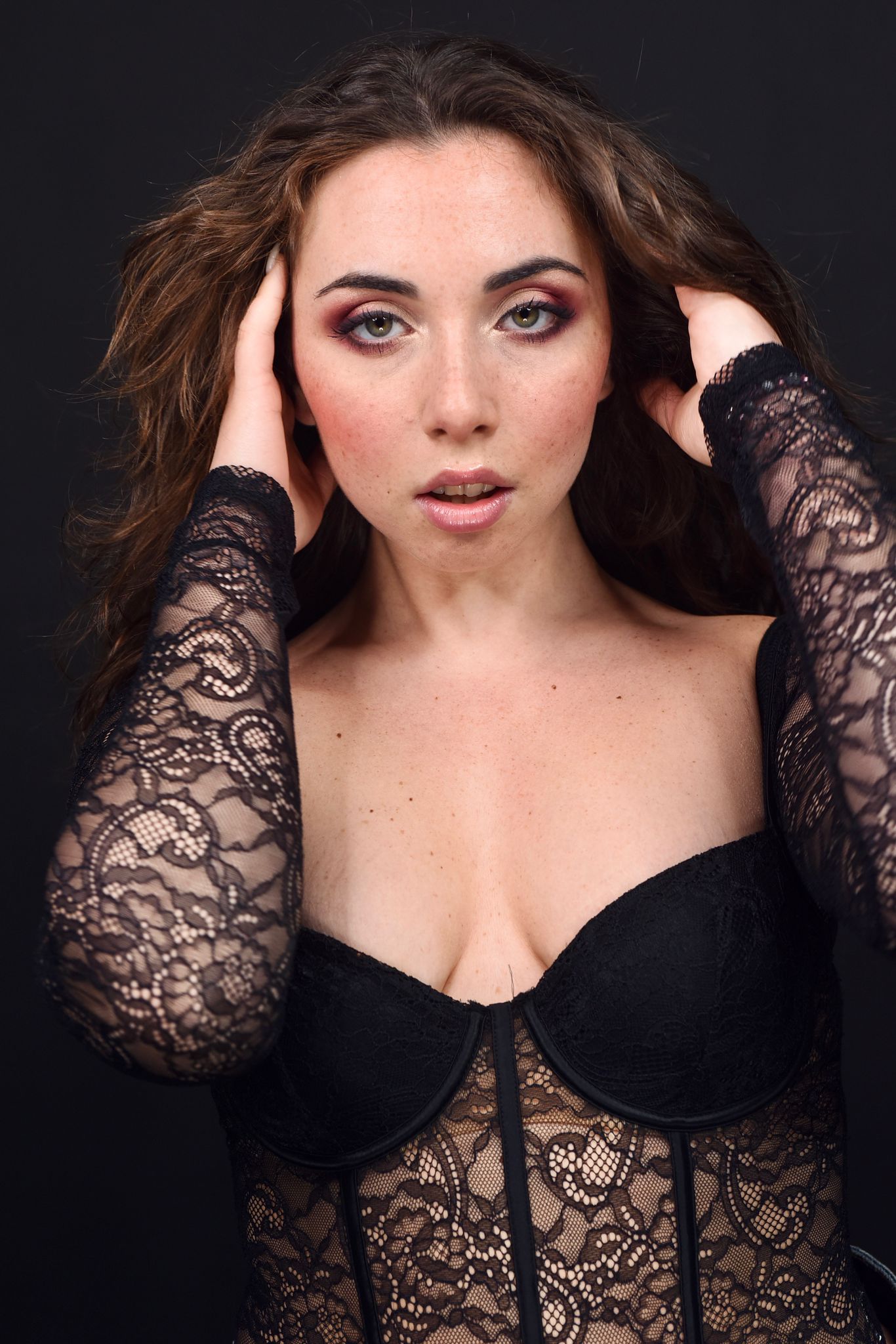 Three people in a field wearing white suits