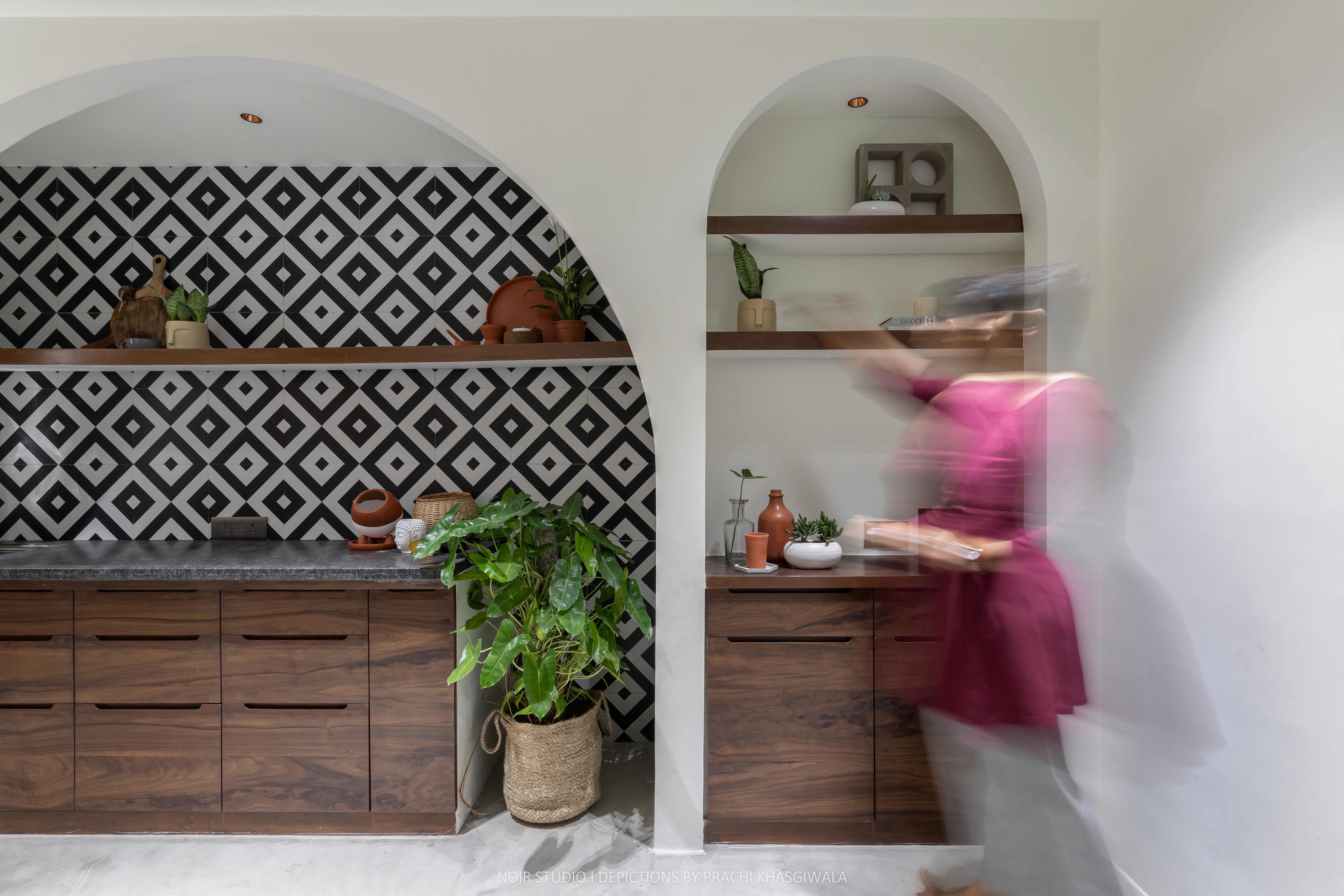 Black and white image of people working at a table with laptops, showing hands gesturing during discussion of digital content displayed on screens, with fabrica® logo in the corner.