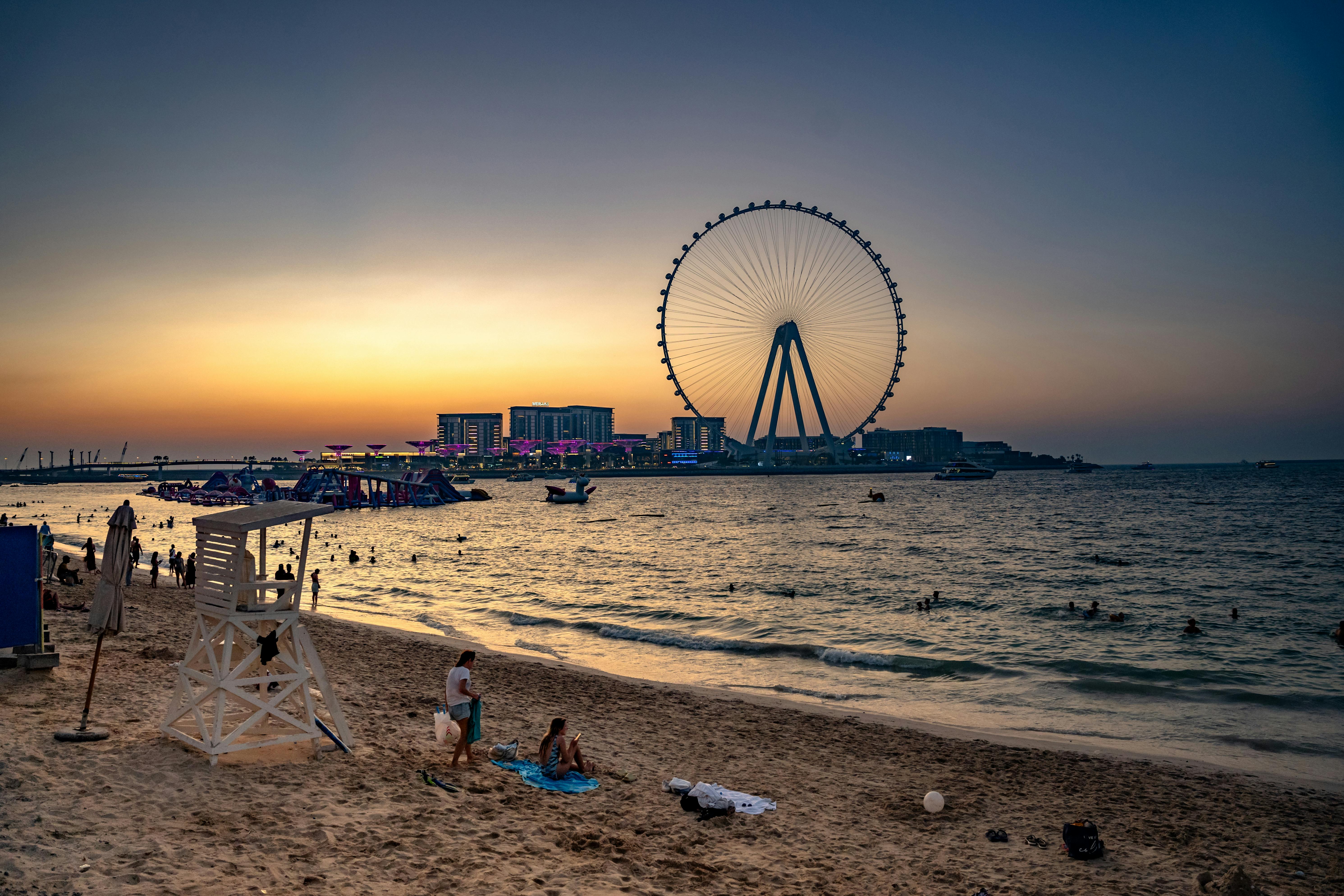 Sunset view of Dubai eye ferris wheel from the beach.