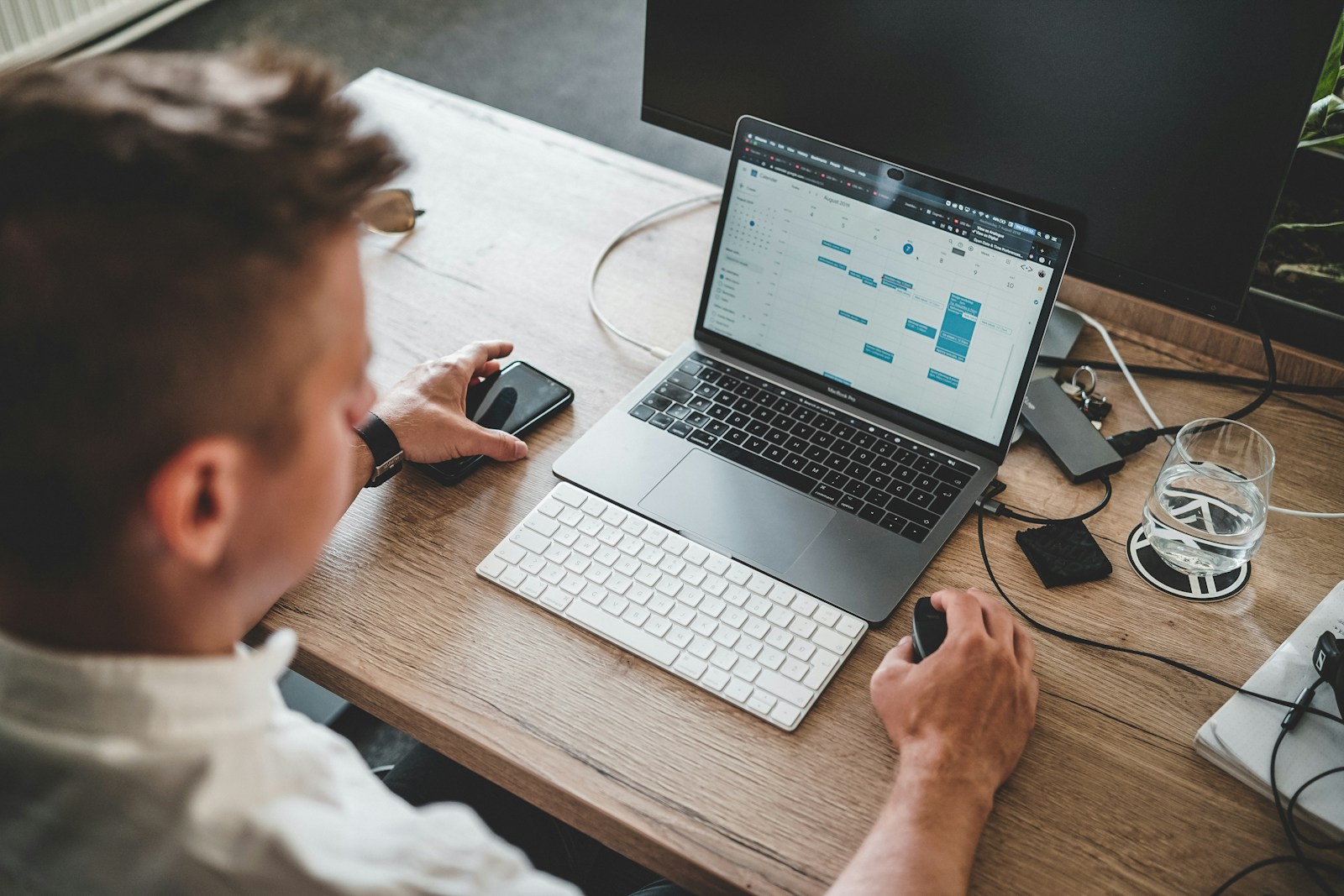 Focused workspace with laptop and planning tools, representing a connected productivity stack