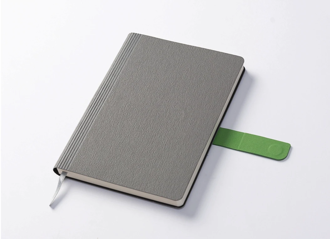 Closed textured grey journal with green strap and ribbon bookmark