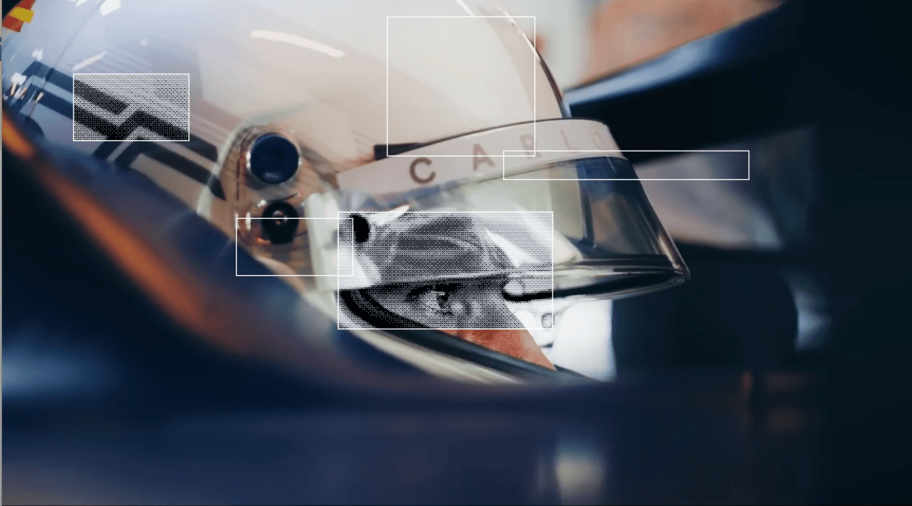 Carlos Sainz sitting in the f1 car with high tech grahics on top