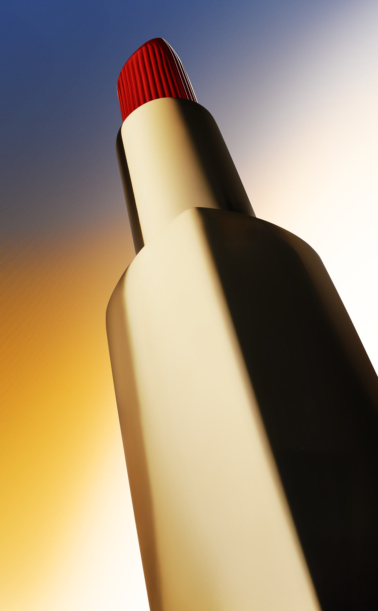 A close-up of a lipstick with a red tip, set against a gradient background of yellow and blue hues.