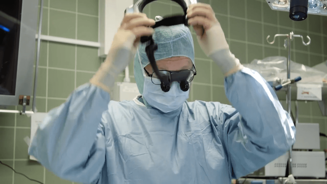 An photo of a clinical professional using a RealWear headset at work