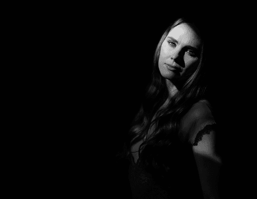 A lighthouse on a beach on a cloudy day