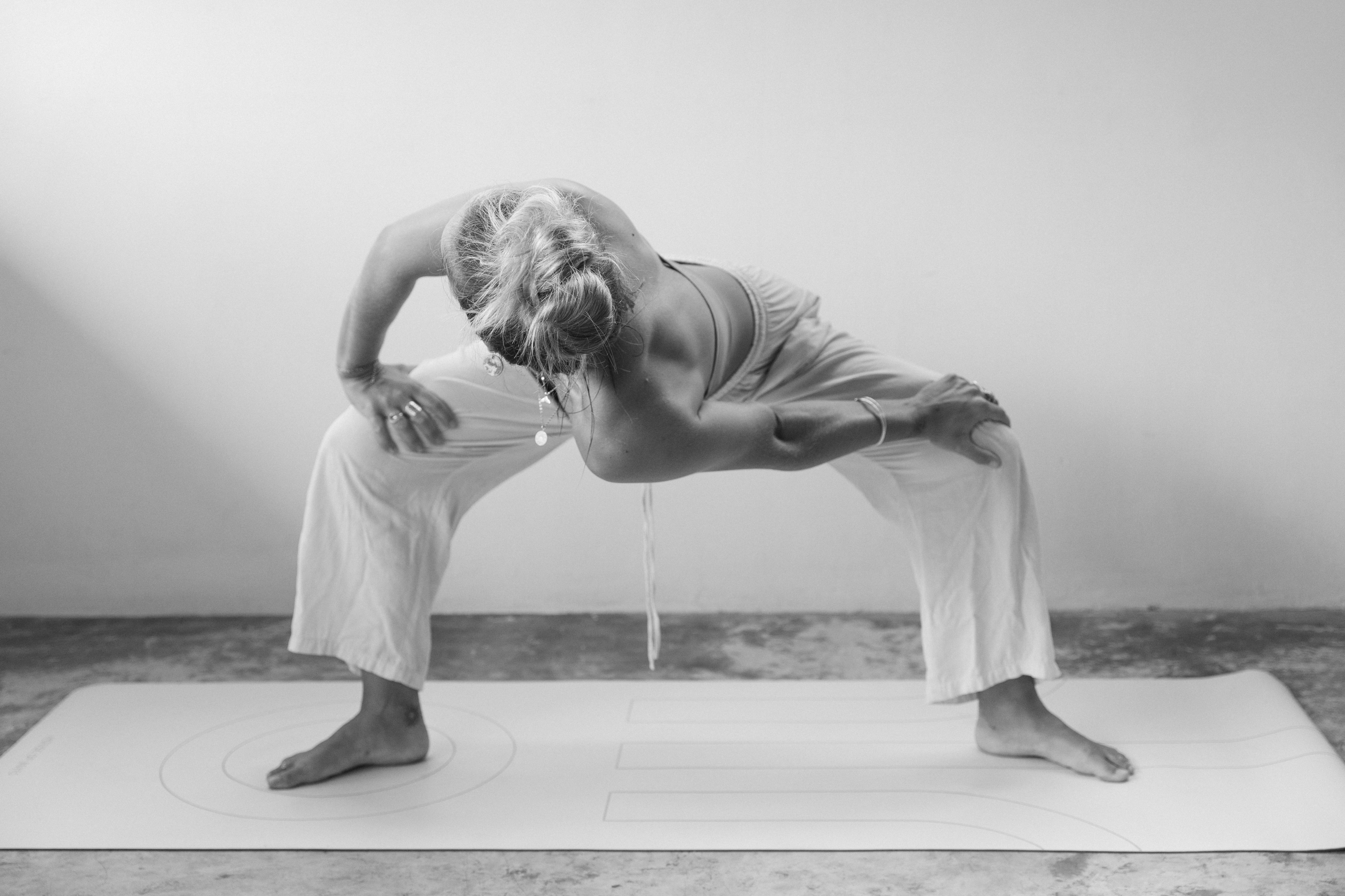 Girl laying in bikini in the sand looking straight into the camera