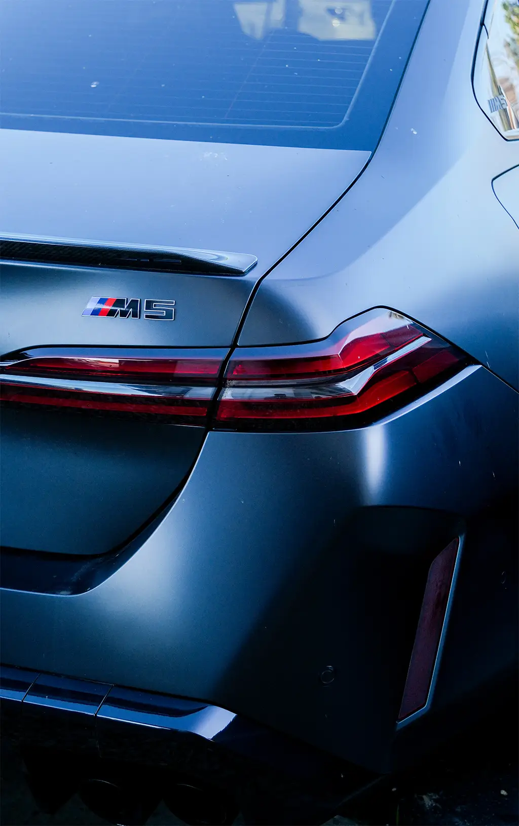 BMW M5 rear panel after paint refinishing service in Simi Valley collision repair shop