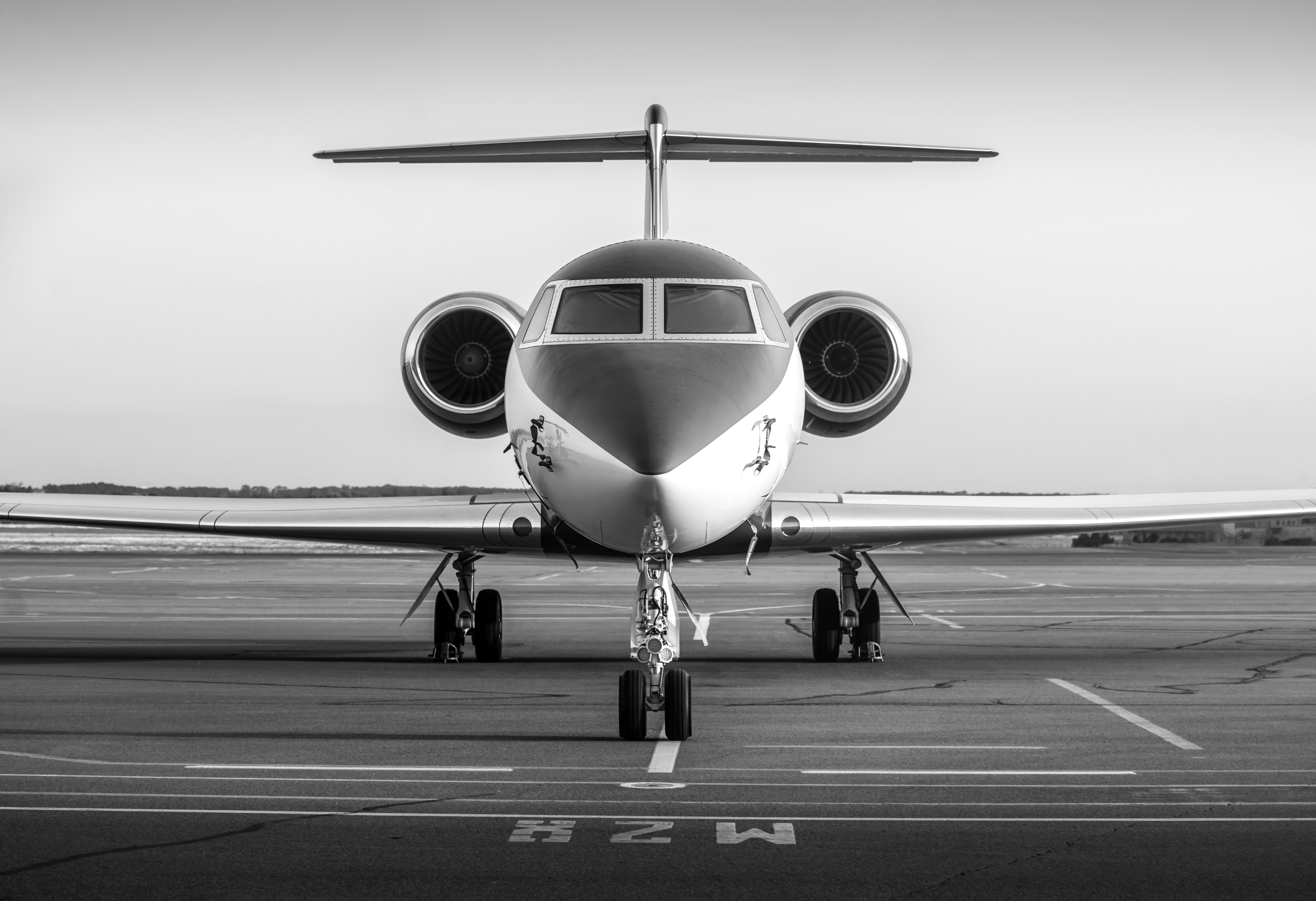 Close-up of a hair dryer nozzle with a black circular vent, against a textured background.