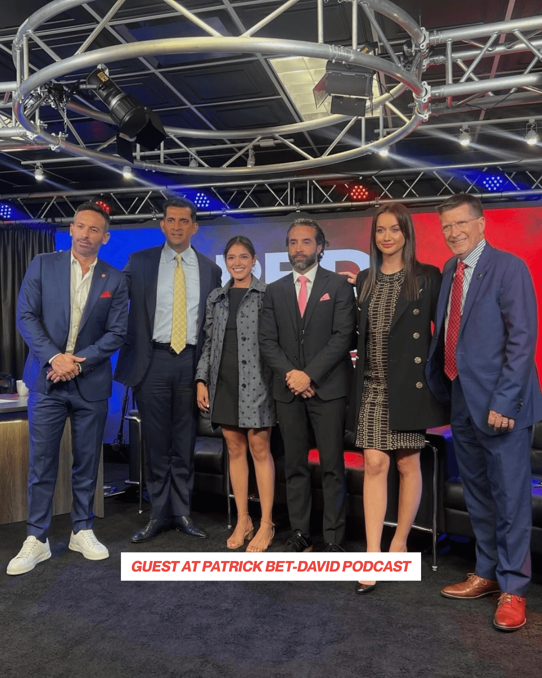Three men cooking food on an outdoor grill.