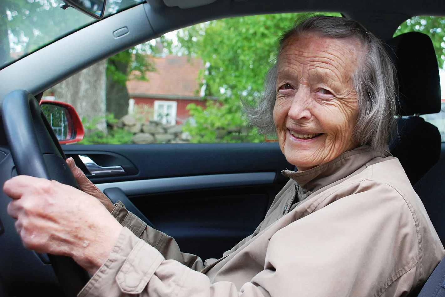 older driver smiling behind the wheel
