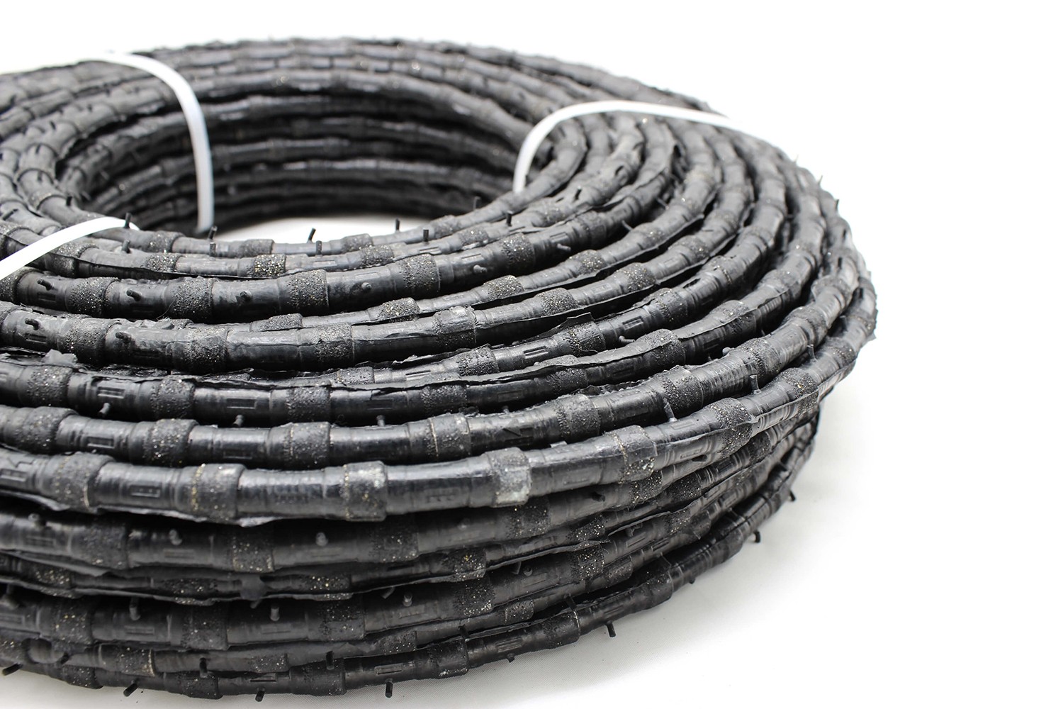 Perspective view of a coiled Diamond Wire Saw used for reinforced concrete cutting.