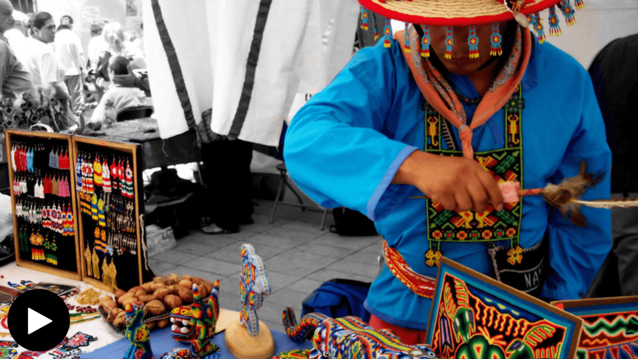 A Wixárika man selling beaded artwork and jewelry.