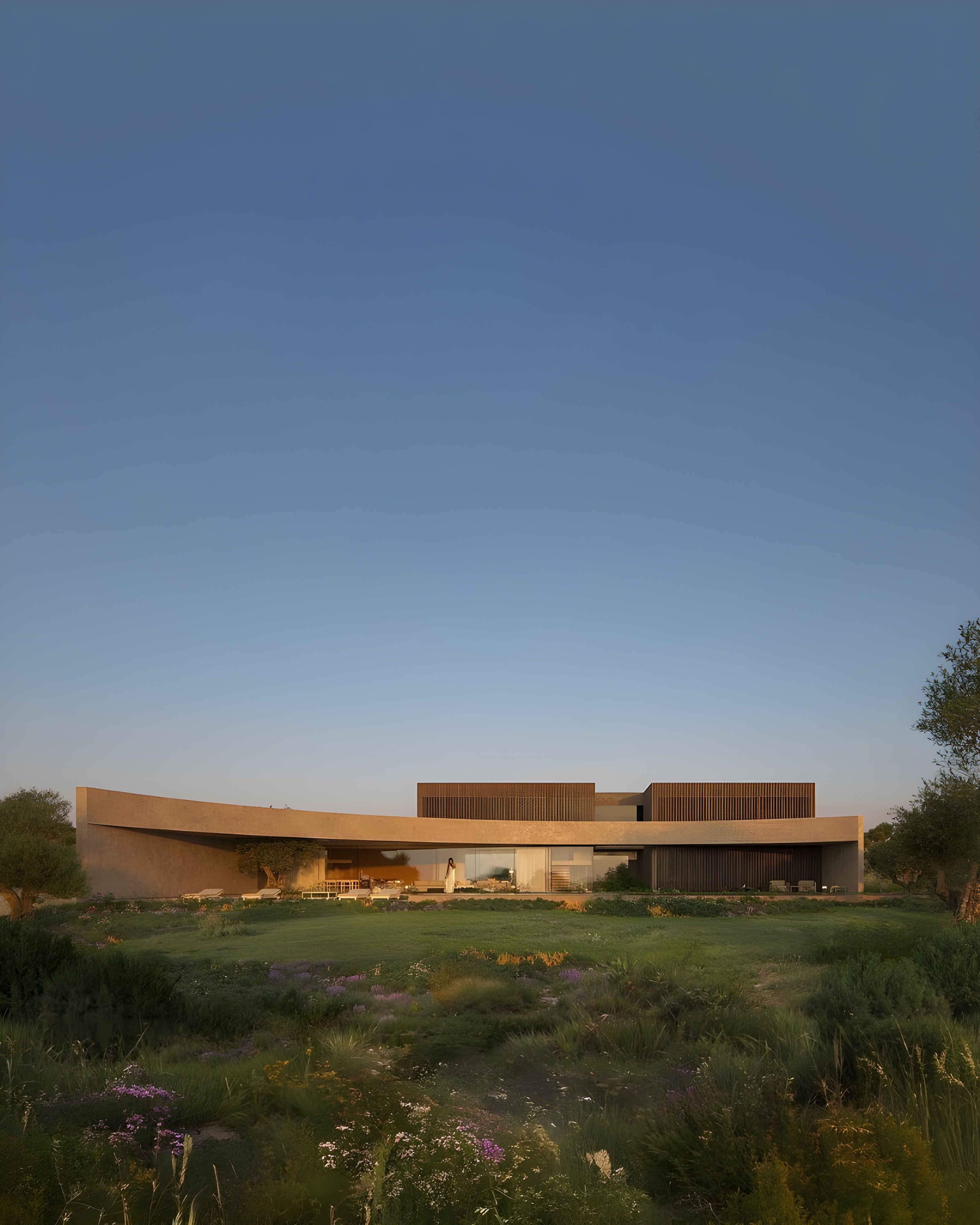 Modern home architecture with curved roof and lush landscape