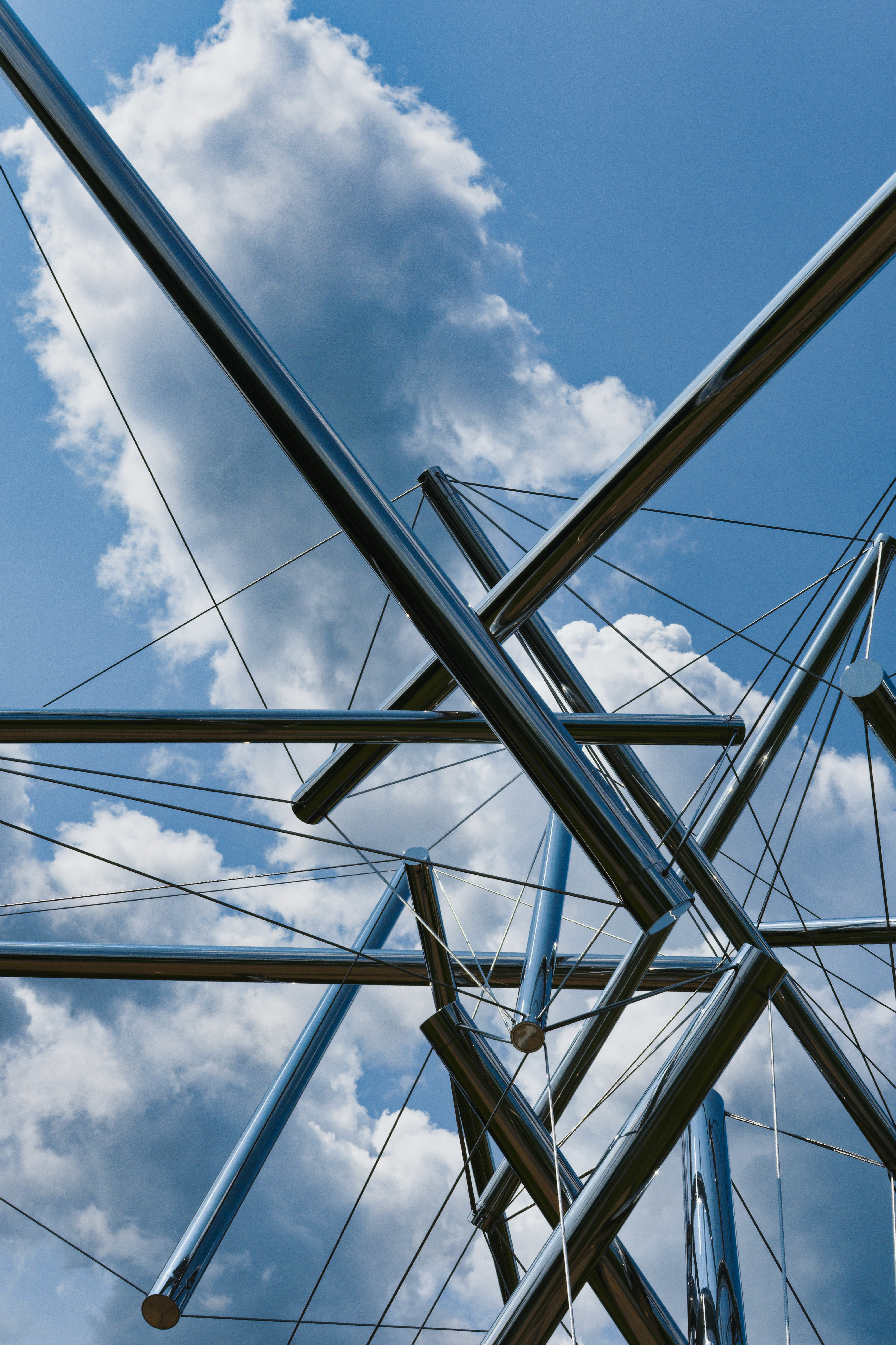 a group of metal poles against a cloudy blue sky
