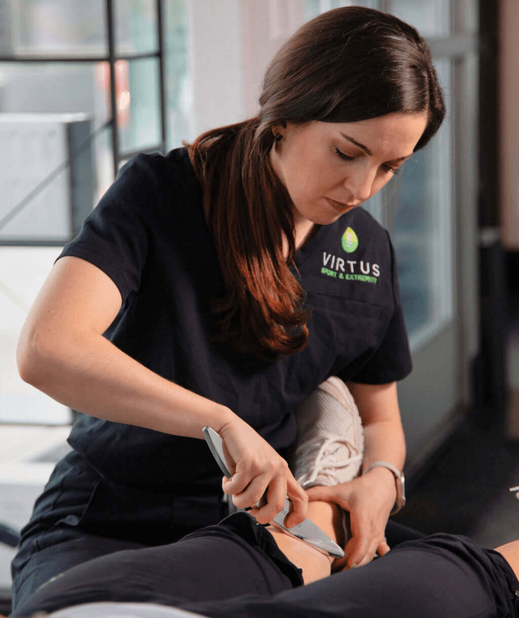 A stylish green armchair next to a modern lamp, set against a dark wall for a cozy atmosphere.