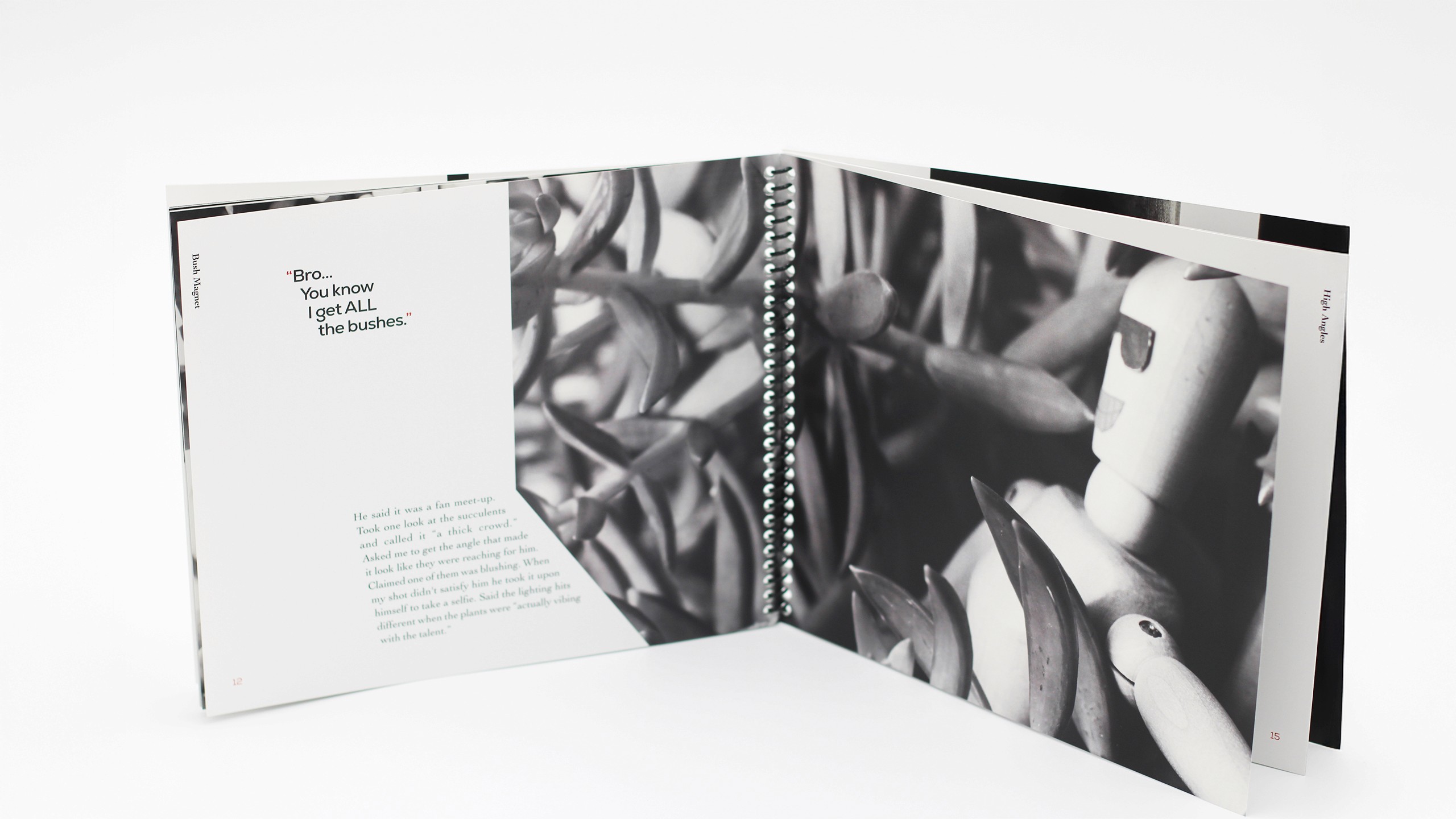 Publication spread. Left, text descring the black and white photograph to the right. It conforms to the cut out shape of the the photograph. Right, black and white photograph of drawing mannequin. The subjects sits in bushes wears sunglasses and a smile made from paper. Its arm is extended to look as if the subject is taking a selfie.