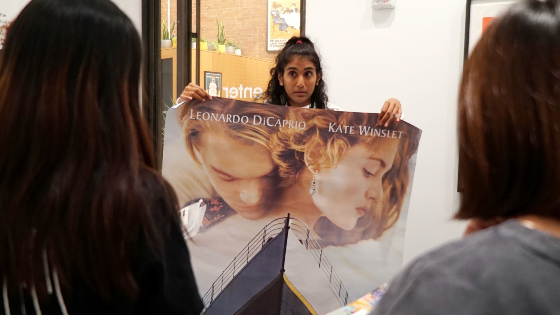 Maya Varadaraj giving a tour of Poster House museum to students