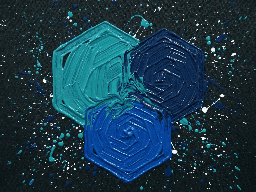 Abstract swirling colors in shades of teal, orange, and purple, creating a dynamic and fluid visual effect.