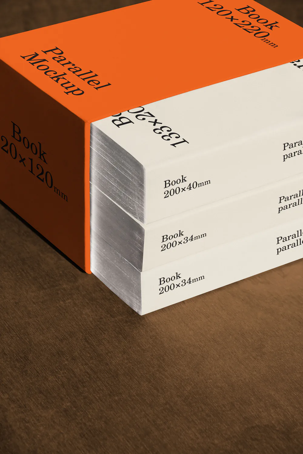 A close-up of a stack of white boxes with an orange top label, resting on a dark wooden surface.