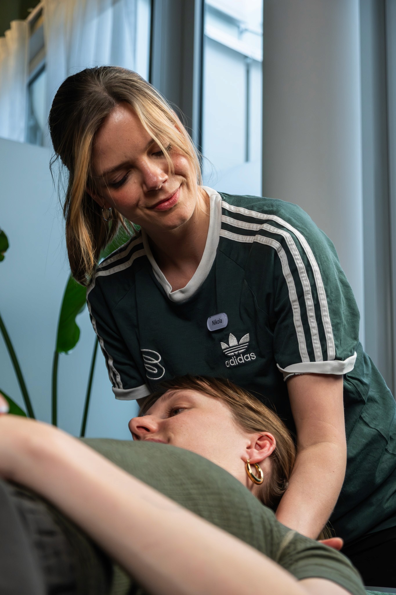 A physiotherapist uses hands-on methods with a patient during a manual therapy session