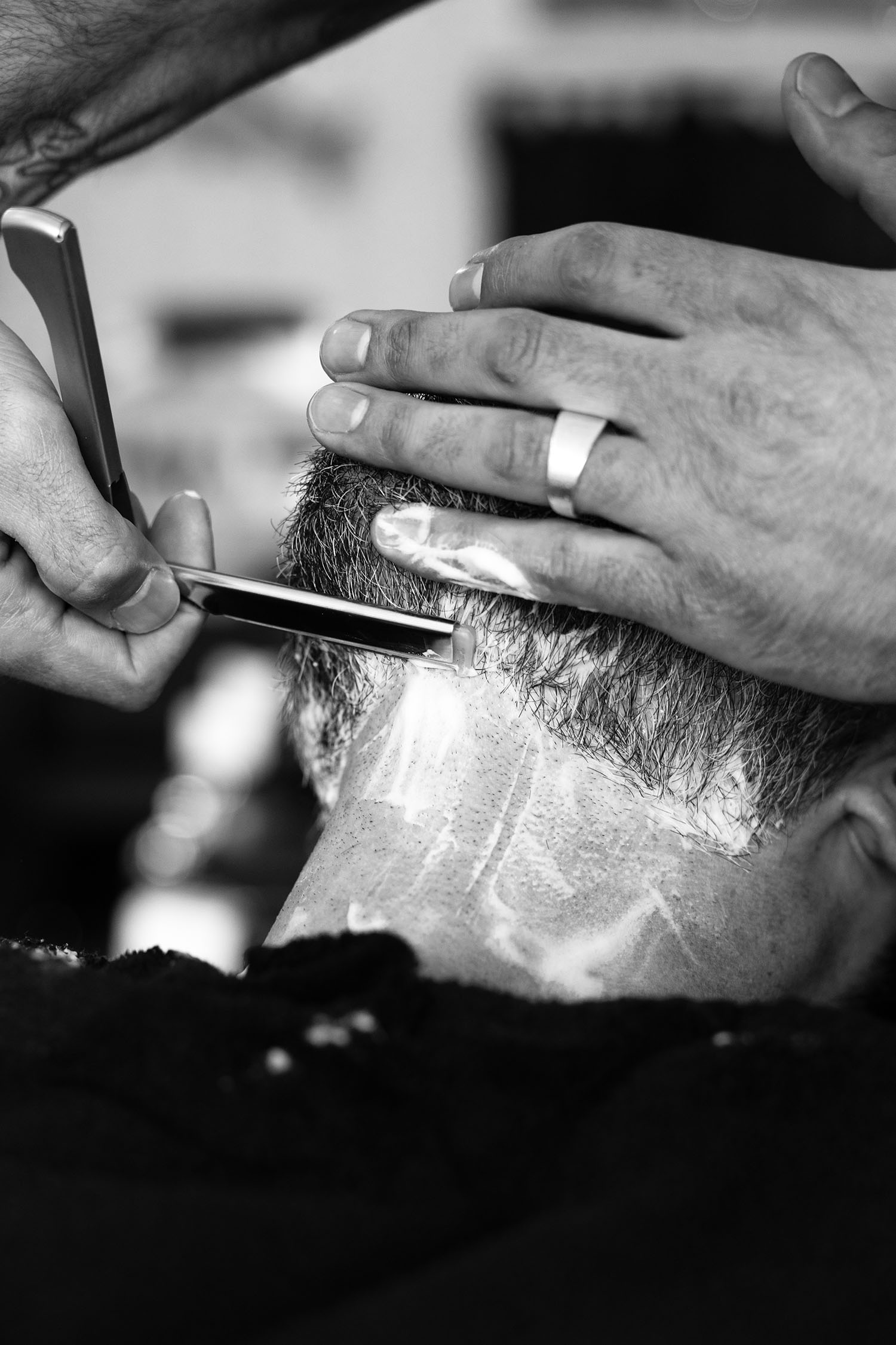 Traditional straight razor shave performed by a barber at Calderone’s Barbershop