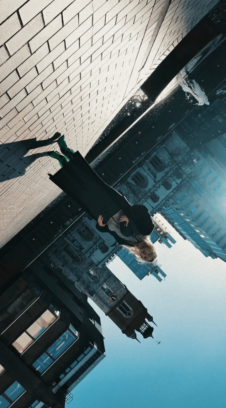 Woman hugging Shiba Inu dog in front of white fence