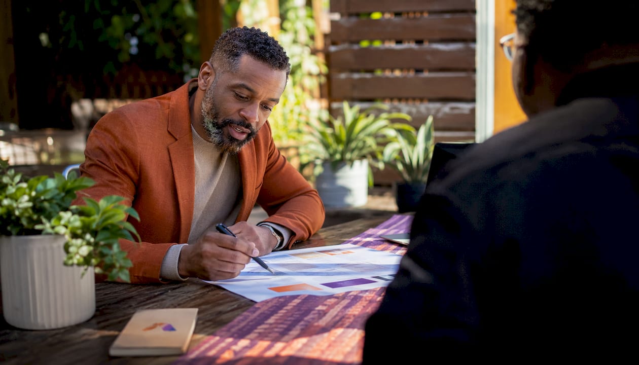 Event planner reviewing agenda with colleague