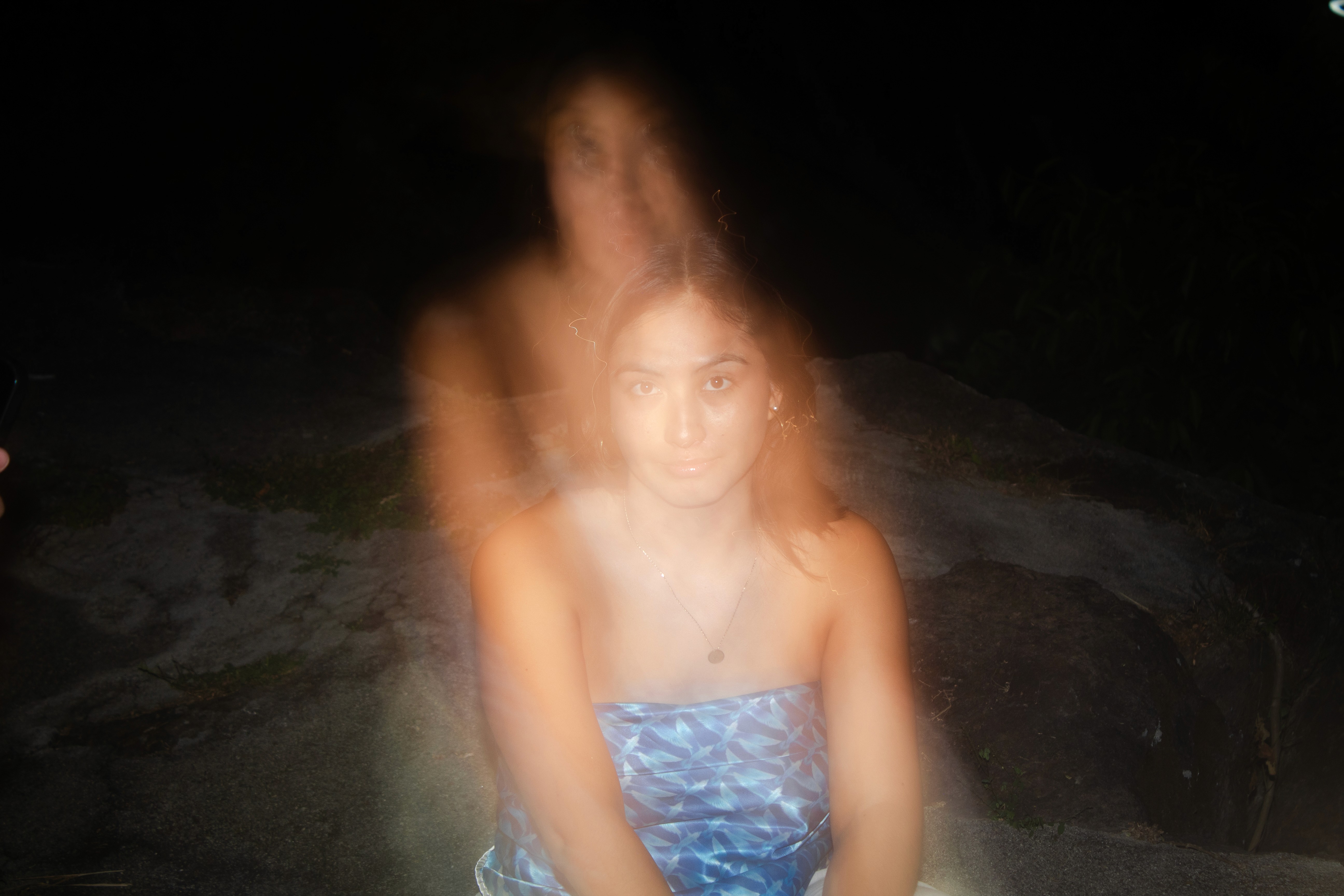 a blurry photo of a person standing in front of a wall