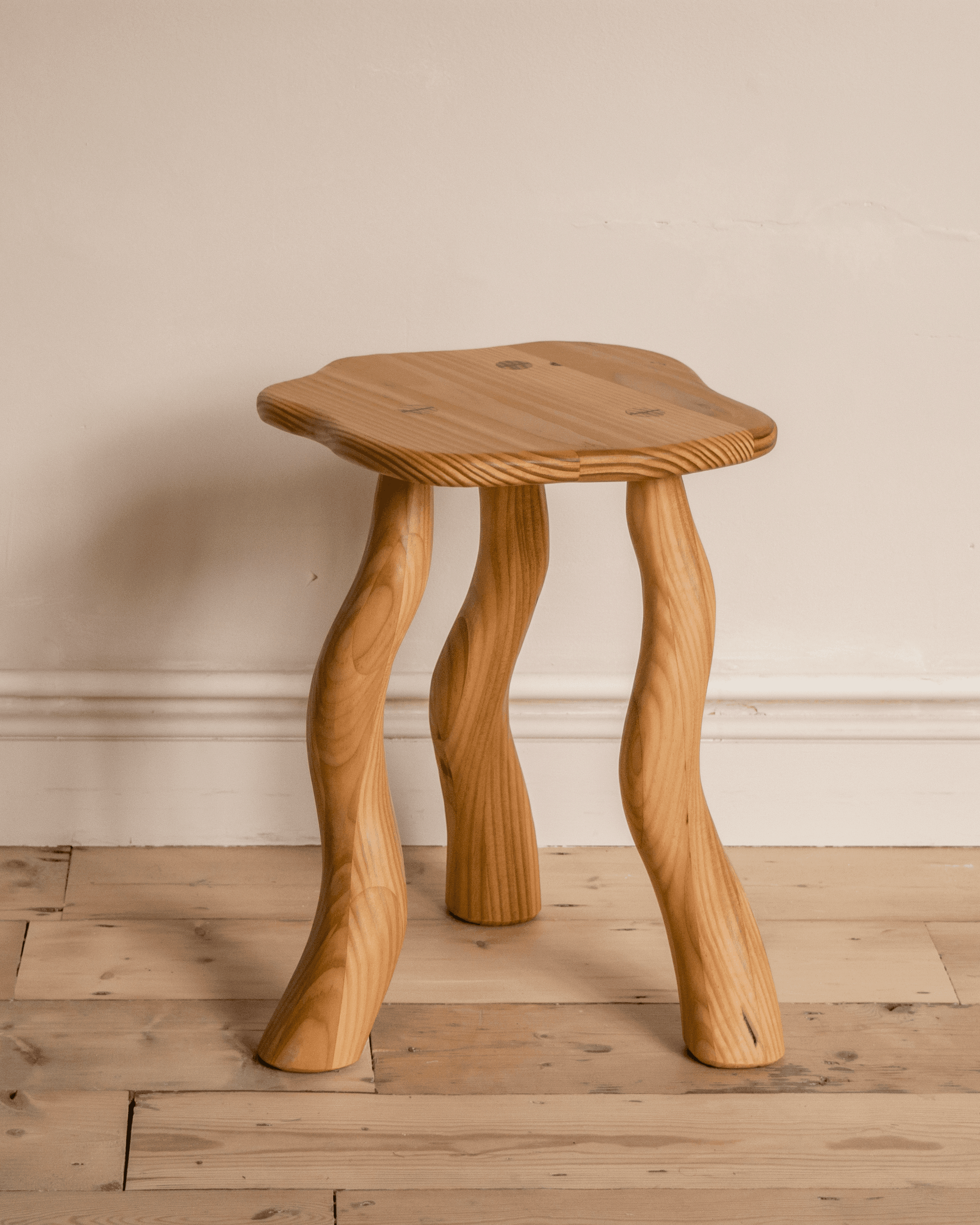 Douglas fir Dancing Stool with carved wavy legs by Wilkinson & Rivera.