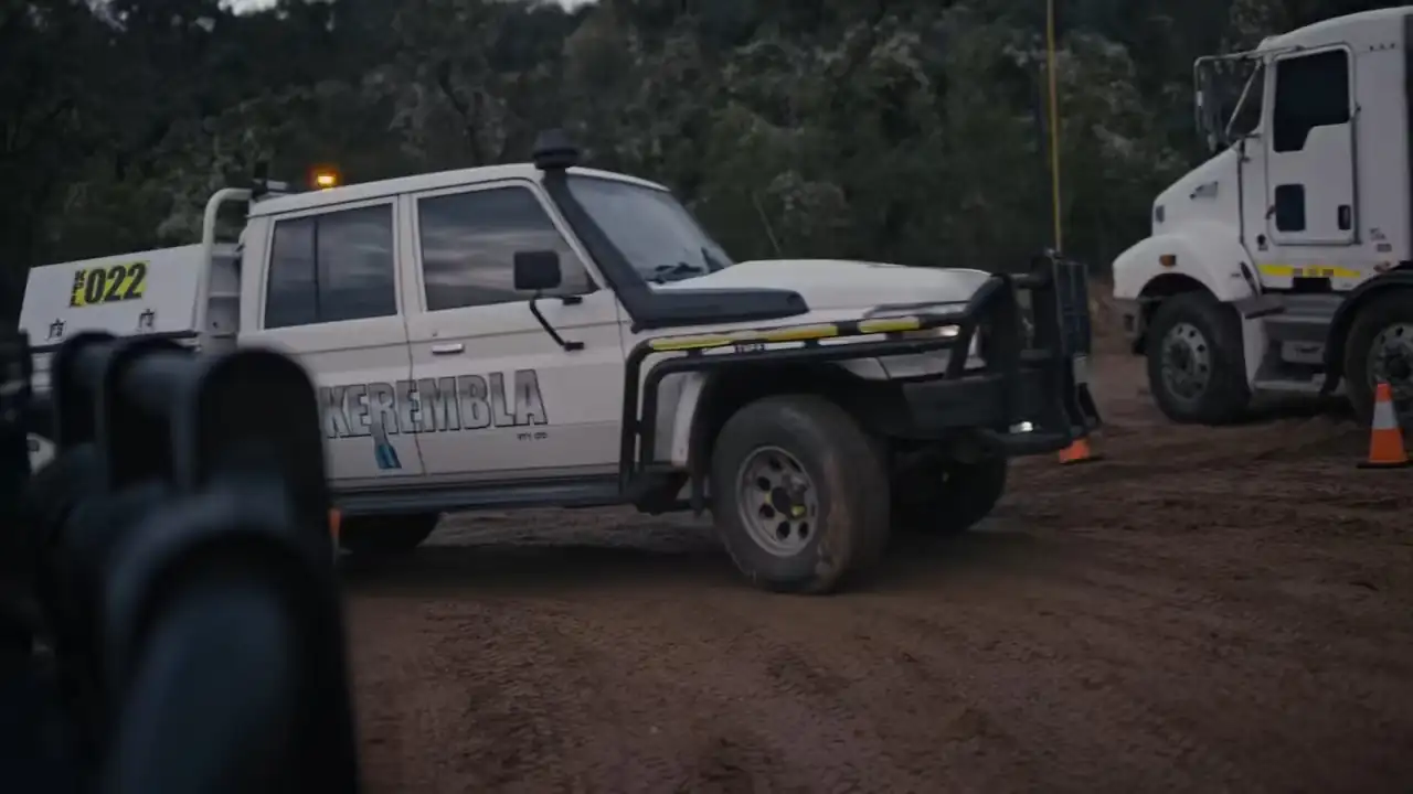 A truck driving up a dirt road