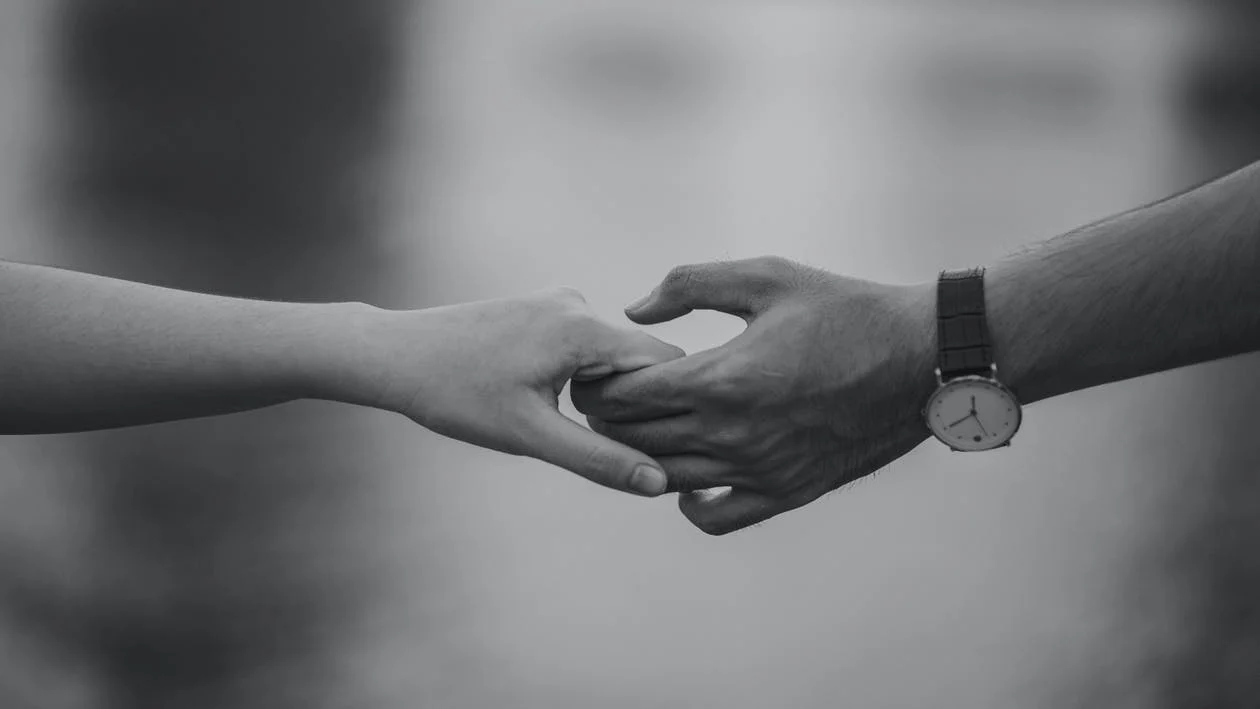 An image showing two hands holding hands