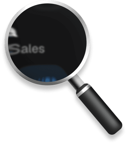 Magnifying glass with a black handle is zoomed in on the word "Sales" on a computer screen.