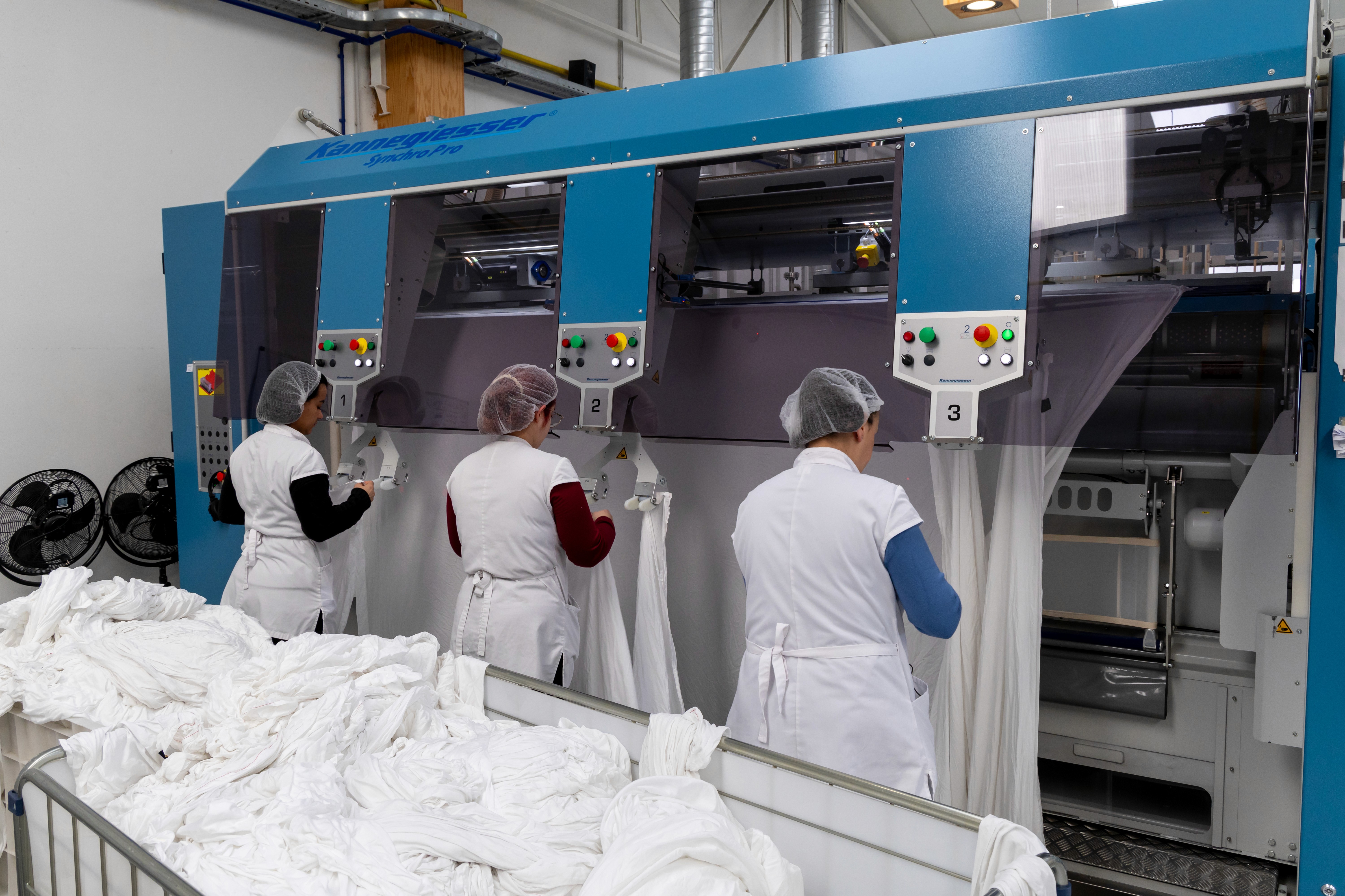 man wearing gray polo shirt beside dry-erase board