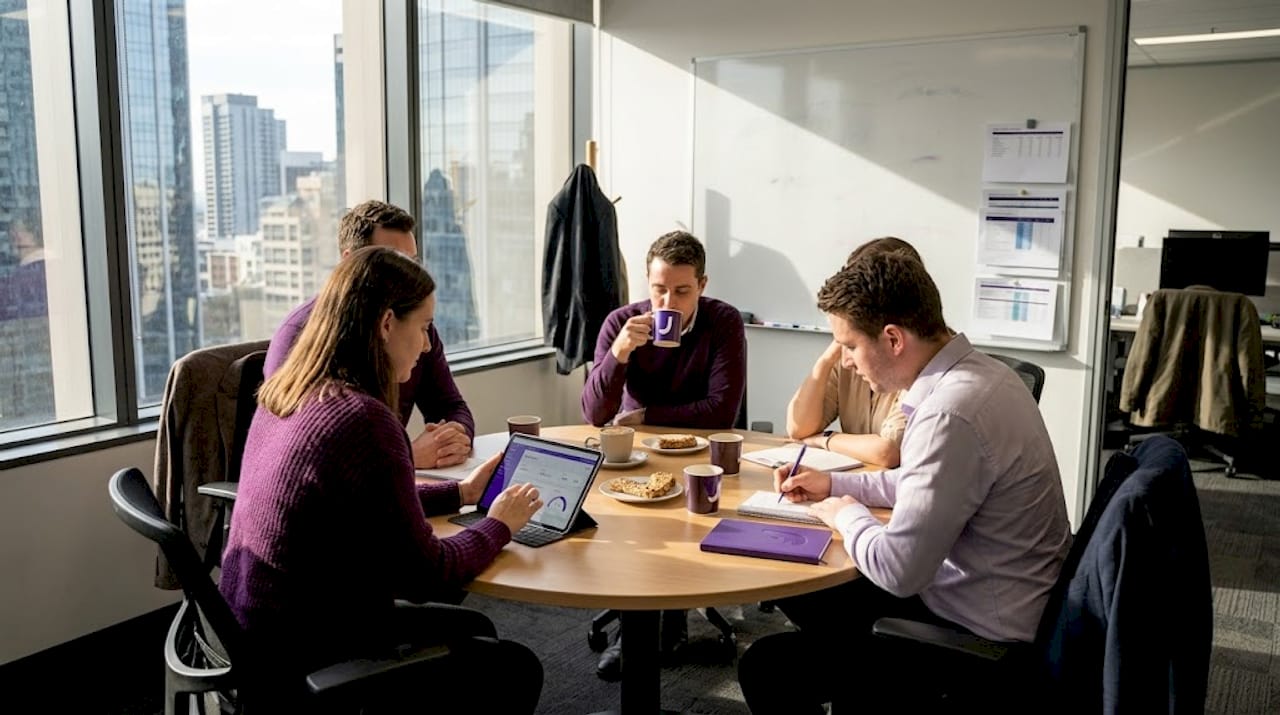 Team collaborates on digital commerce at meeting table