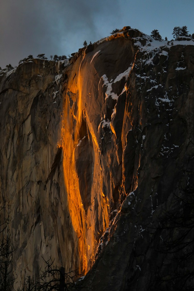 Brown and grey rocky mountain with an orange glow