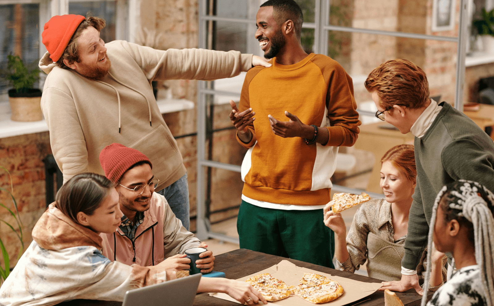 Group of adults laughing and eating