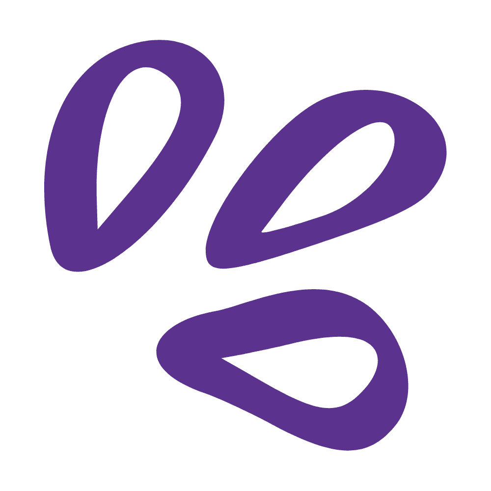 Restaurant interior with wooden tables and chairs lined against a textured wall, softly lit by round wall lamps.