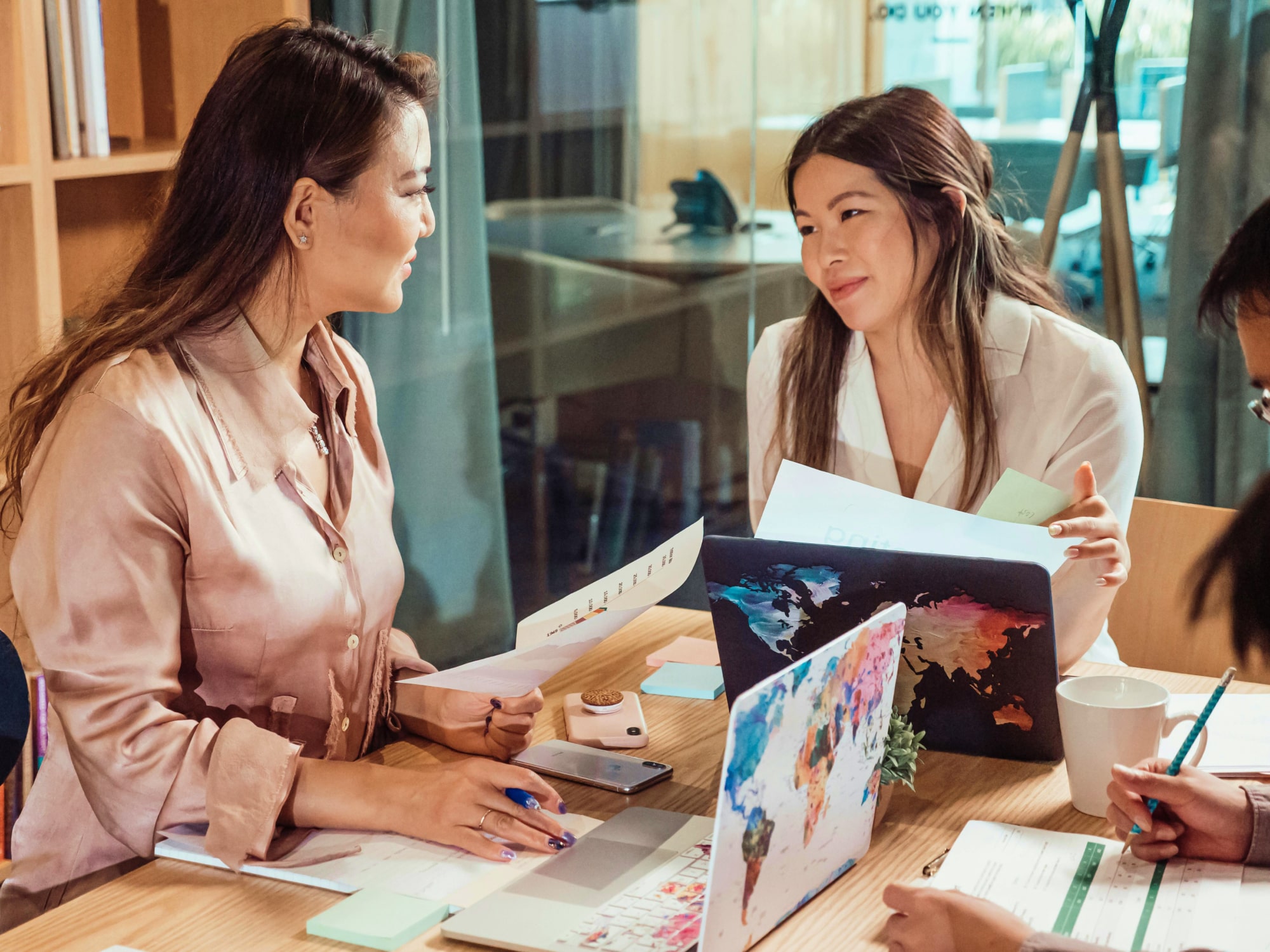 Two female founders of a Foundation sitting on an office table discussing ideas