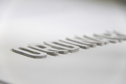 a close-up of letters cut outs from paper and stacked