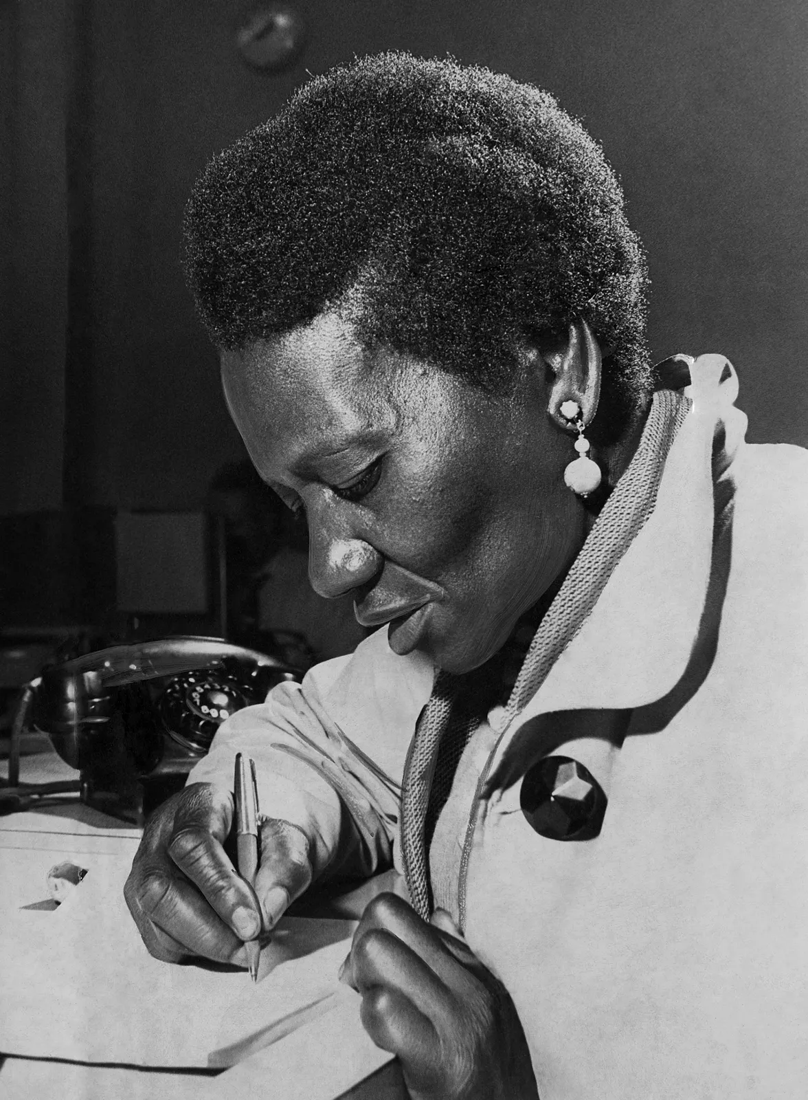 Man with flower petal held between lips