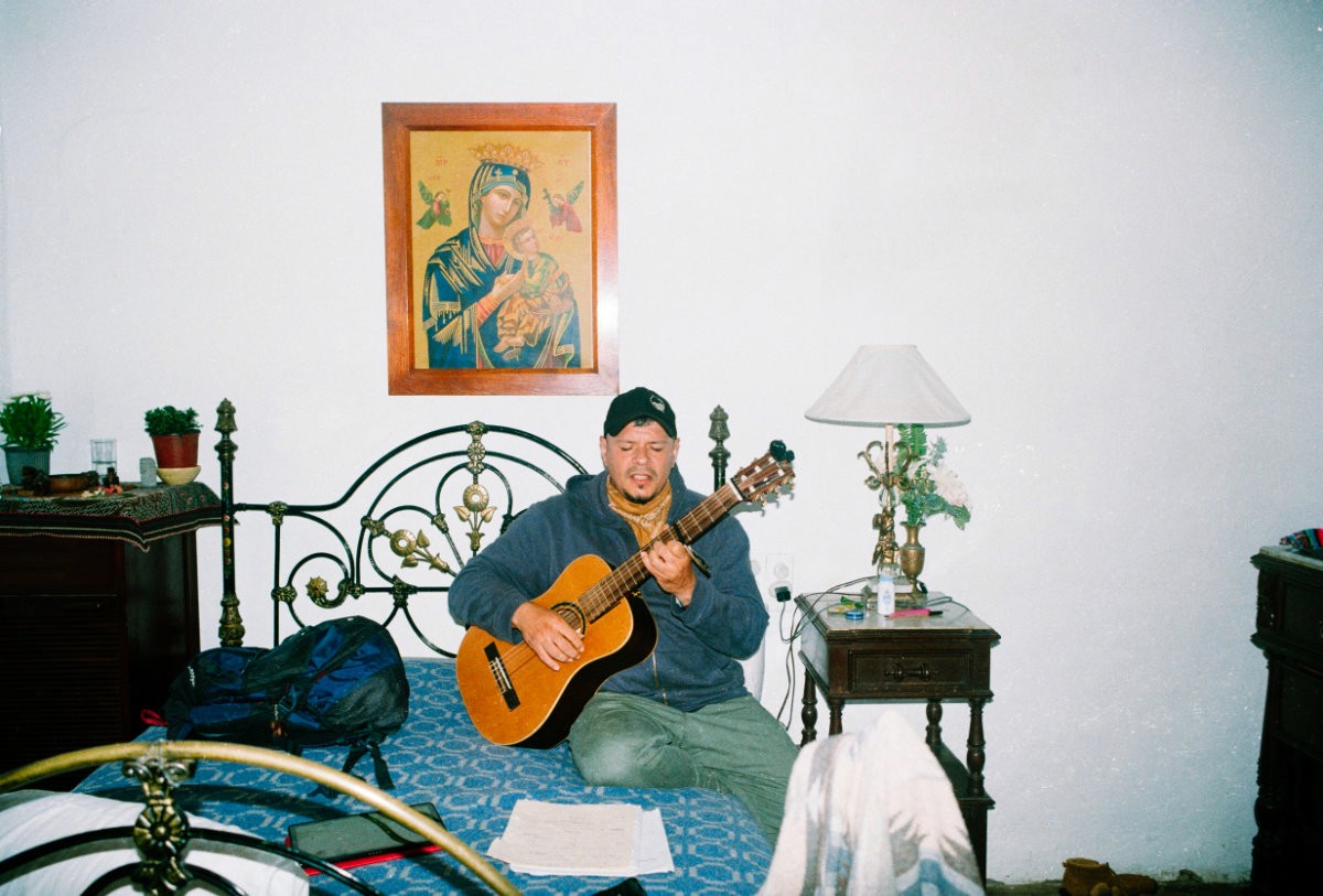 Person playing guitar in a retreat house in Ecuador