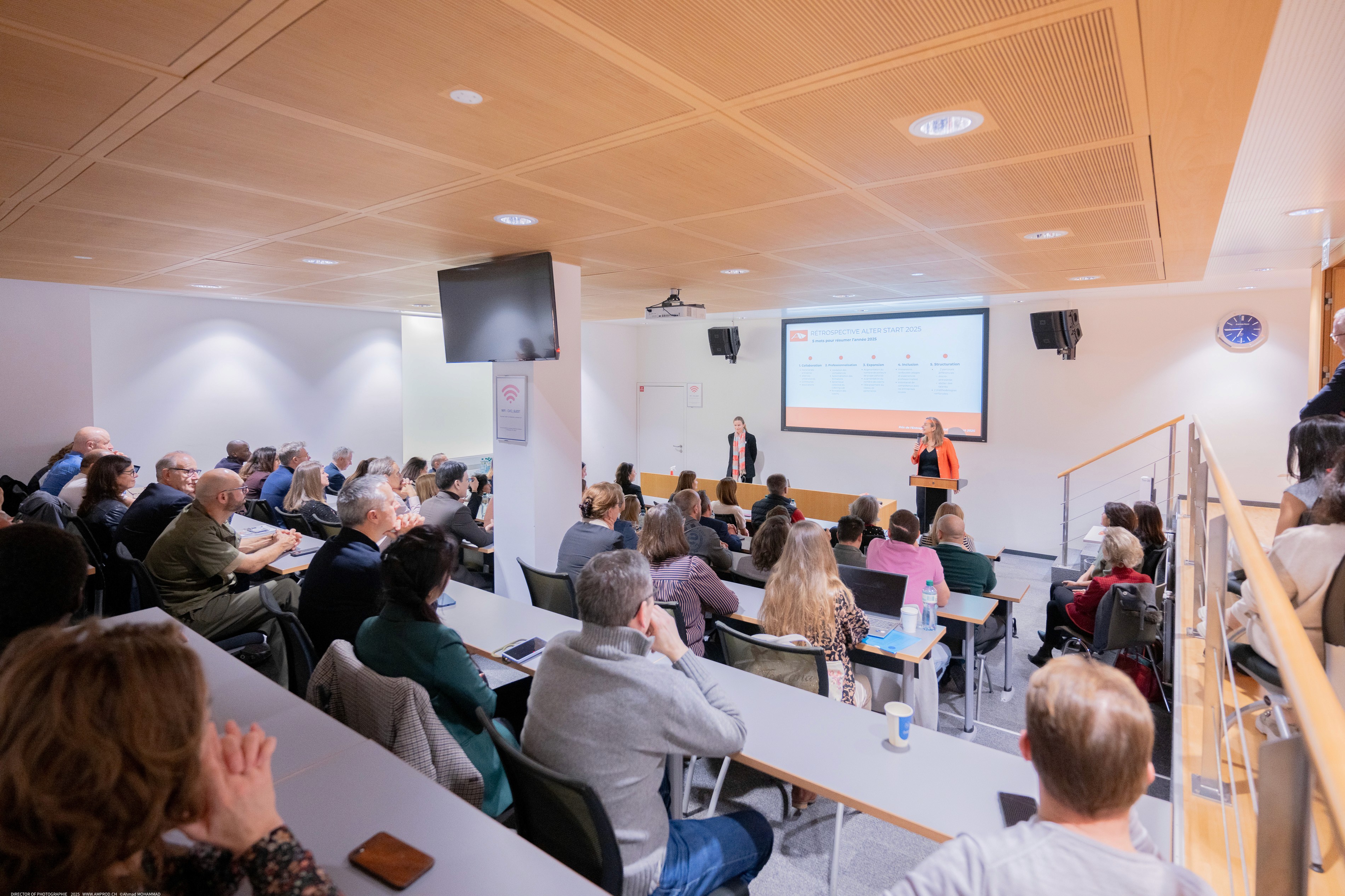 Workshop attendees smiling for a group photo during an indoor business event